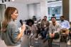 A woman gives a talk to a room of colleagues