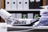 A robot hand using a calculator