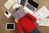 College student hiding face under book, exam stress