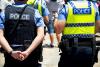 Two police officers from behind