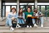 A happy group of students pose on a flight of steps