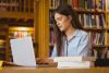 Young scholar working in library
