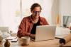 Male student studying at laptop