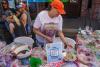 A person selling baked goods at a fundraising event