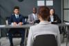 Young black woman before panel during job interview