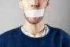 A man with tape on his mouth