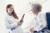 Young female medical researcher with elderly female patient