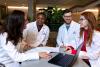 Medical students in discussion around a table