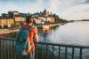 A young man admiring a view from a bridge in Stockholm