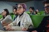 Woman with coloured hair in lecture hall