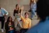 A student holding up his hand in class