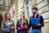 Students smiling outside a university building