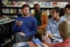 A group of students and a teacher having a discussion in a library