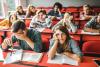 Bored students sit slumped in a lecture hall
