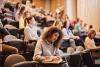 Students in a lecture hall working on essays