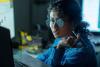 A programmer reviewing code on her desktop