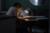 A woman works alone at a desk