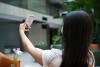 A student filming herself on her phone