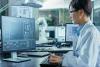 Asian scientist working at computer