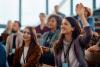 Students raising their hands in class