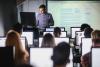 A professor teaches from the front of class