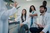 STEM students discuss ideas in a lab