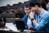 Chinese students working together at a laptop