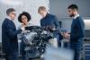 Four engineers considering an automotive problem