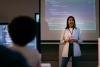 Female instructor in class before screen with code